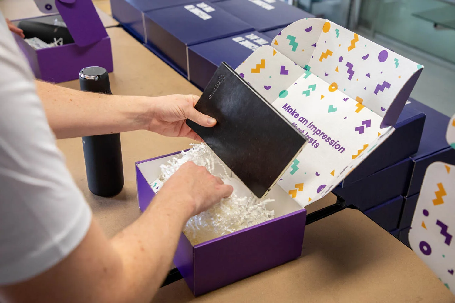 Packing a branded welcome box by hand